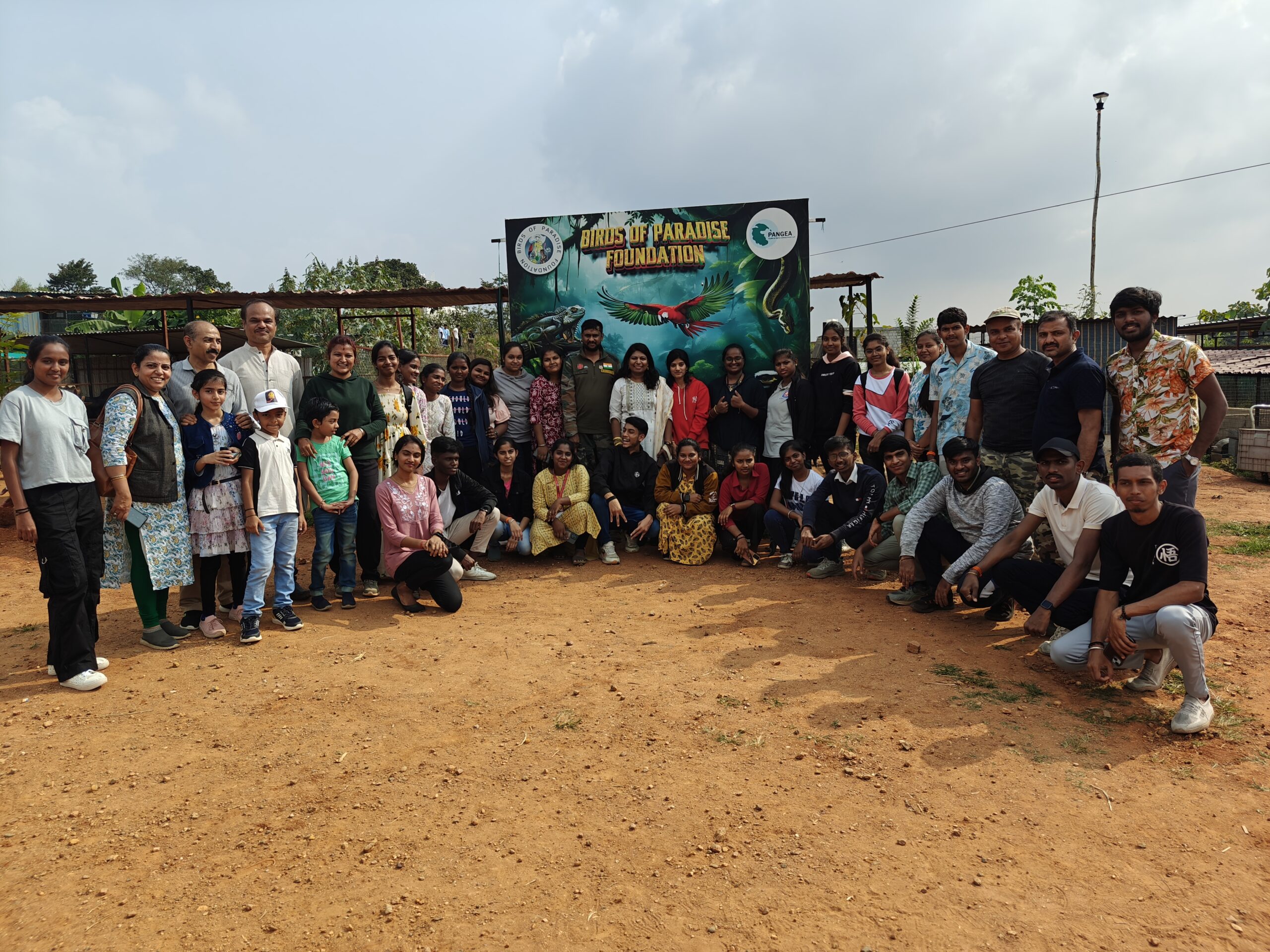 Large group of volunteers and participants posing during Seeds of Change environmental event organized by Giridham Foundation