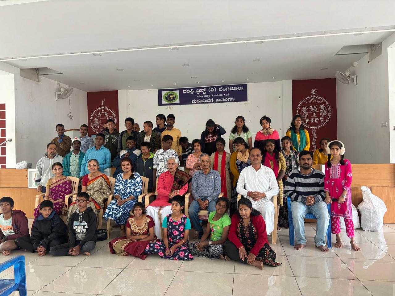 Participants and volunteers gathered during a seva activity at Dharitri Trust organized by Giridham Foundation