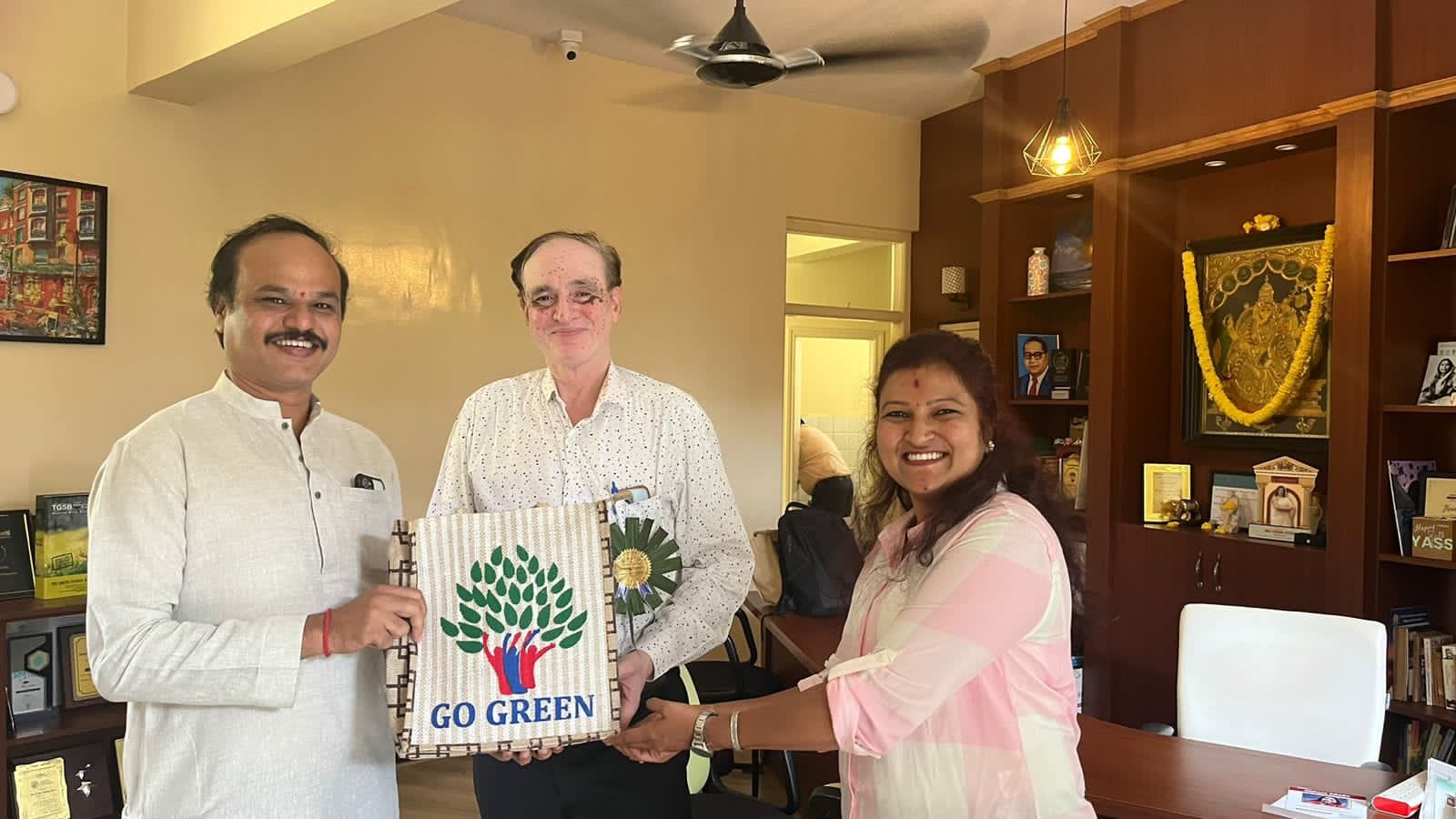 Participants presenting a Go Green eco-friendly message during Seeds of Change event meeting